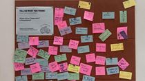 A corkboard full of colorful post-in notes uner the sign "The Philadelphia Challenge."