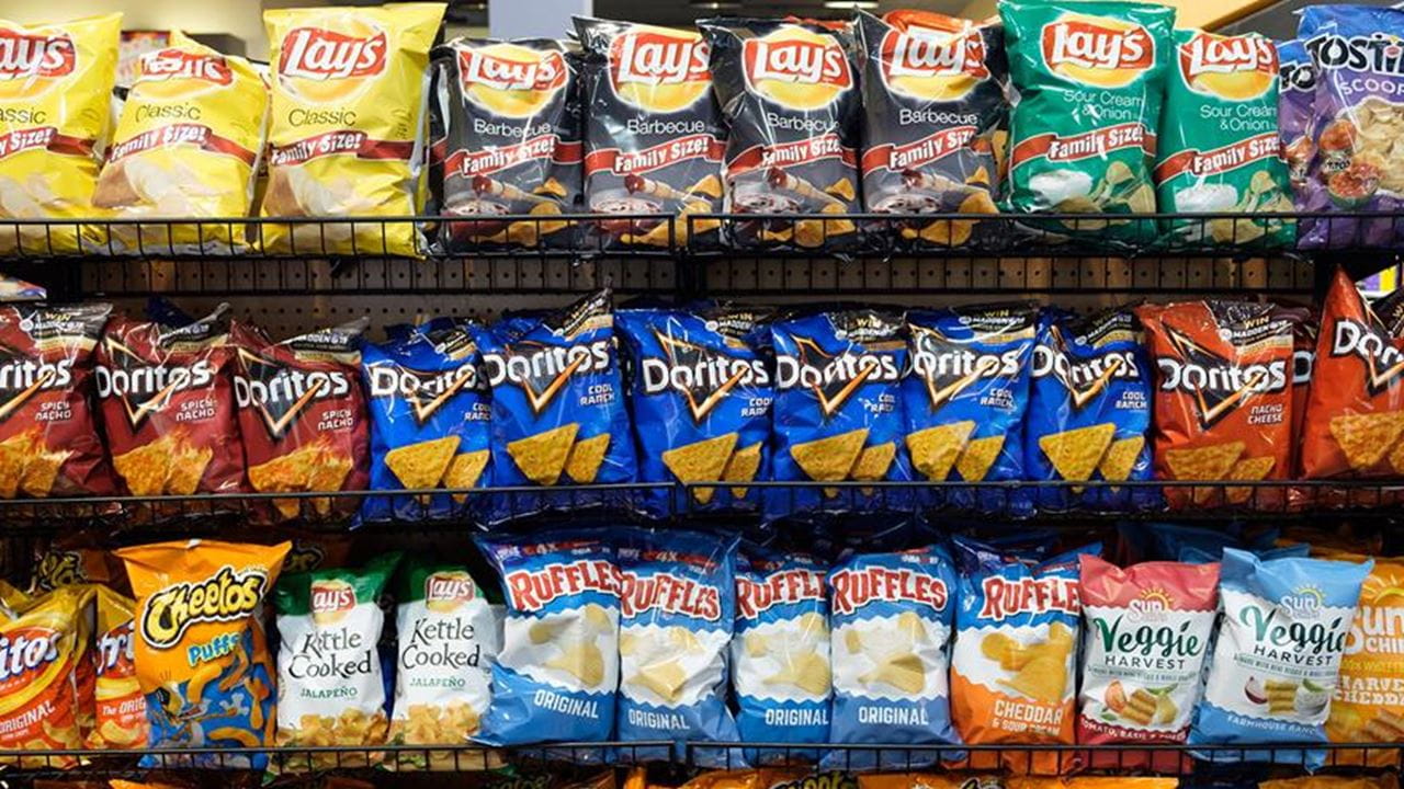 Facing a wall of chips and other ultra-processed snacks in a grocery store aisle