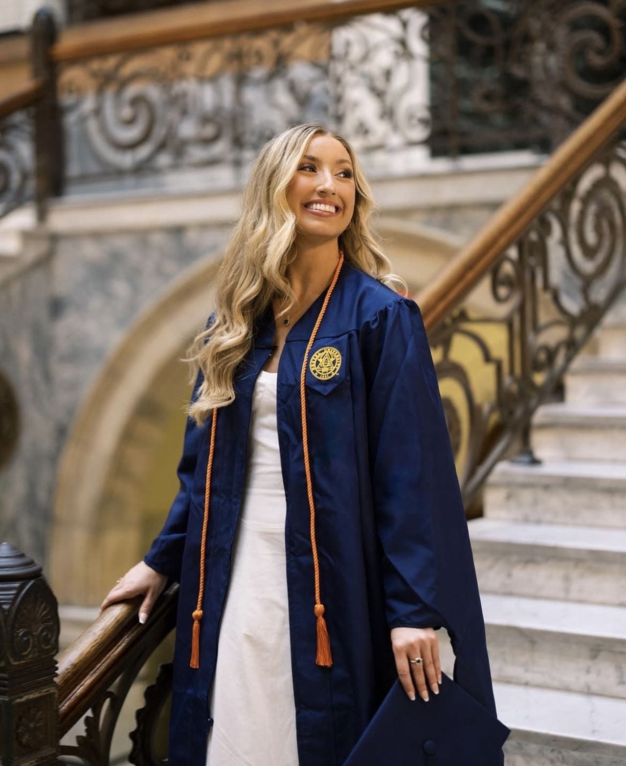 Erin Nipps photographed on the staircase in Drexel’s Main Building for her 2024 MPH commencement. Photo taken by Brandon Lam Photography. Photo courtesy Erin Nipps.