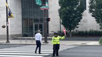A crossing guard stops traffic.