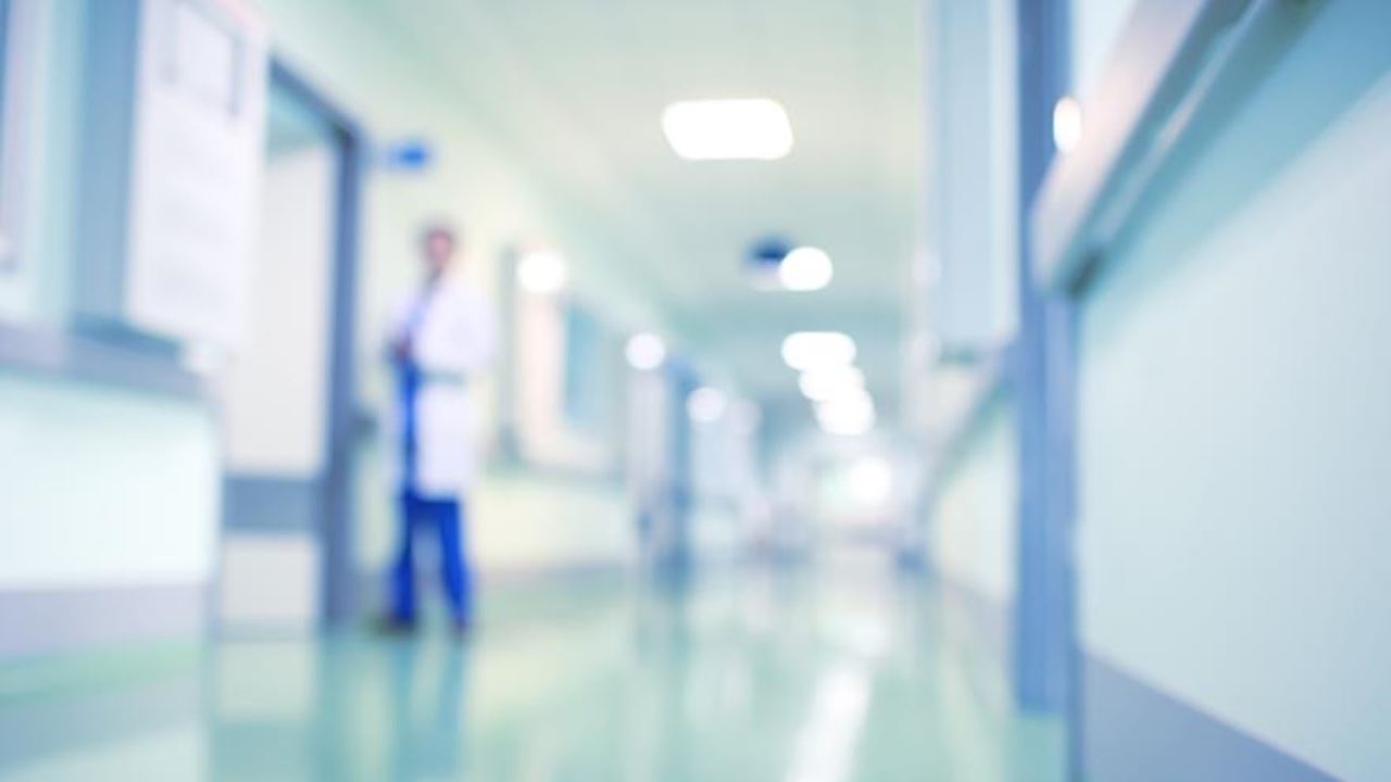 Blurry image of a doctor in a hospital hallway