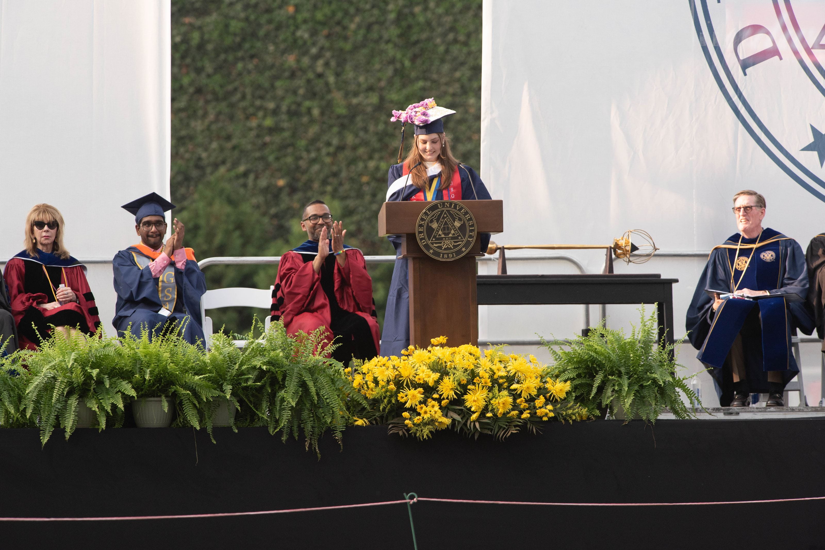 Katie Morcoones speaking on stage