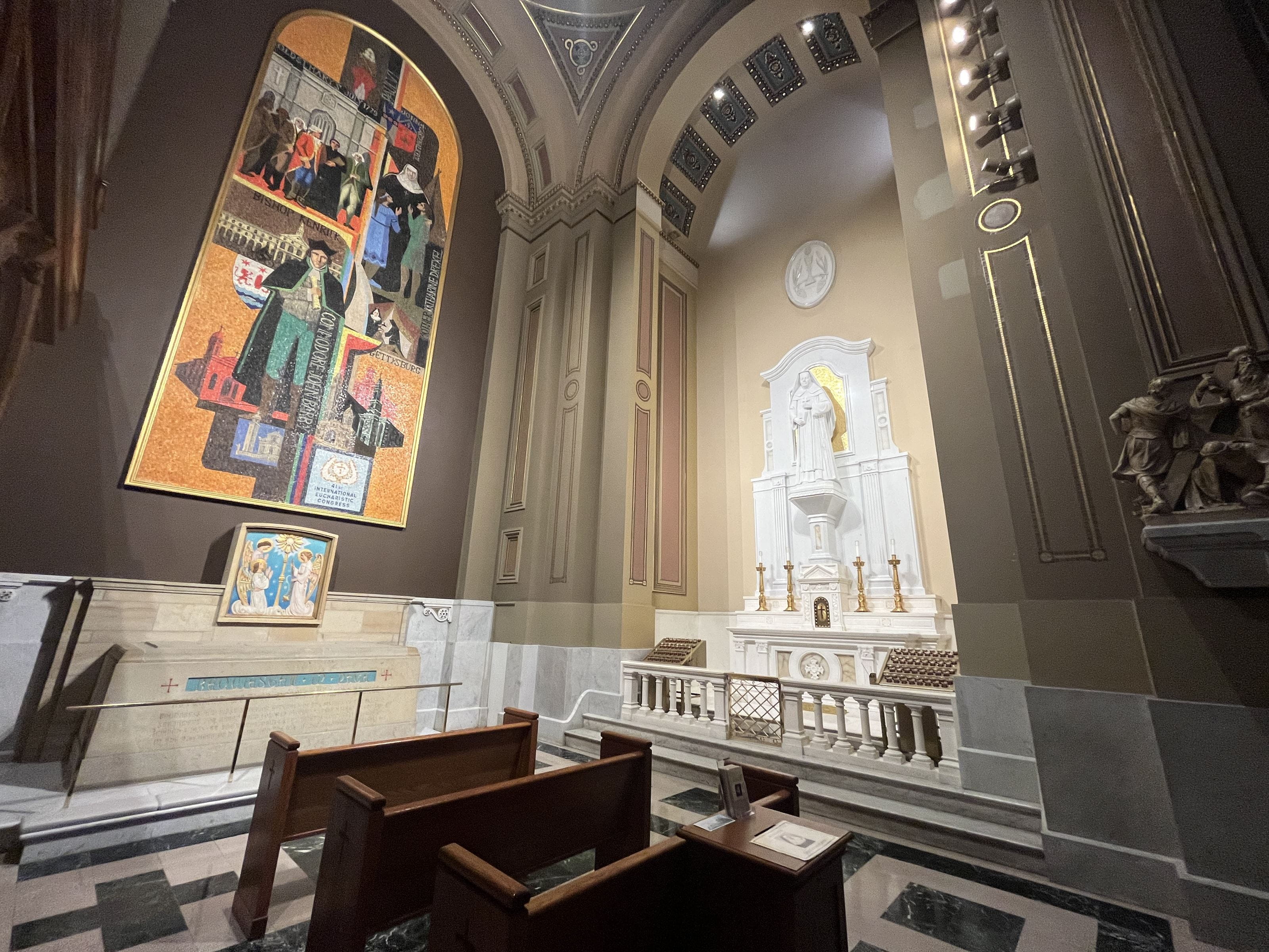 The Shrine to Saint Katharine Drexel, on the right, was dedicated in 2009, and the marble statue is on top of the 19th century altar donated by Saint Katharine and her sisters in honor of their deceased parents. The sacred remains of Saint Katharine Drexel, left, were installed in 2018; the mosaic above it was created in 1975 (a year after the first miracle ascribed to her) and depicts the Catholic Church’s history in Pennsylvania, including then-Mother Katharine Drexel in the top right.