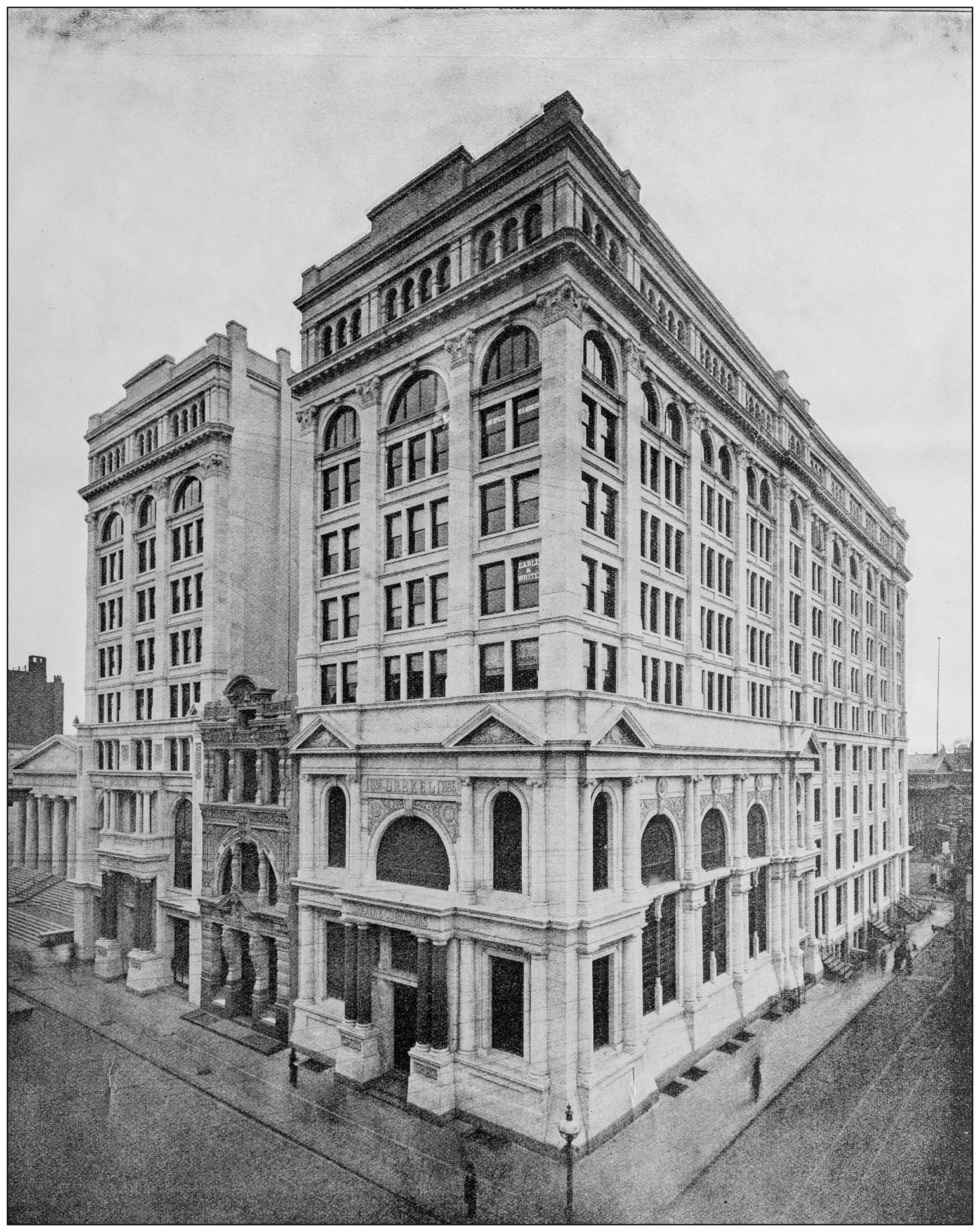 An undated photograph of the Drexel Building on Fifth Street. The building in the middle is what Anthony could not buy and instead built around. Note the “Drexel” written on the street-facing side of the building on the right.