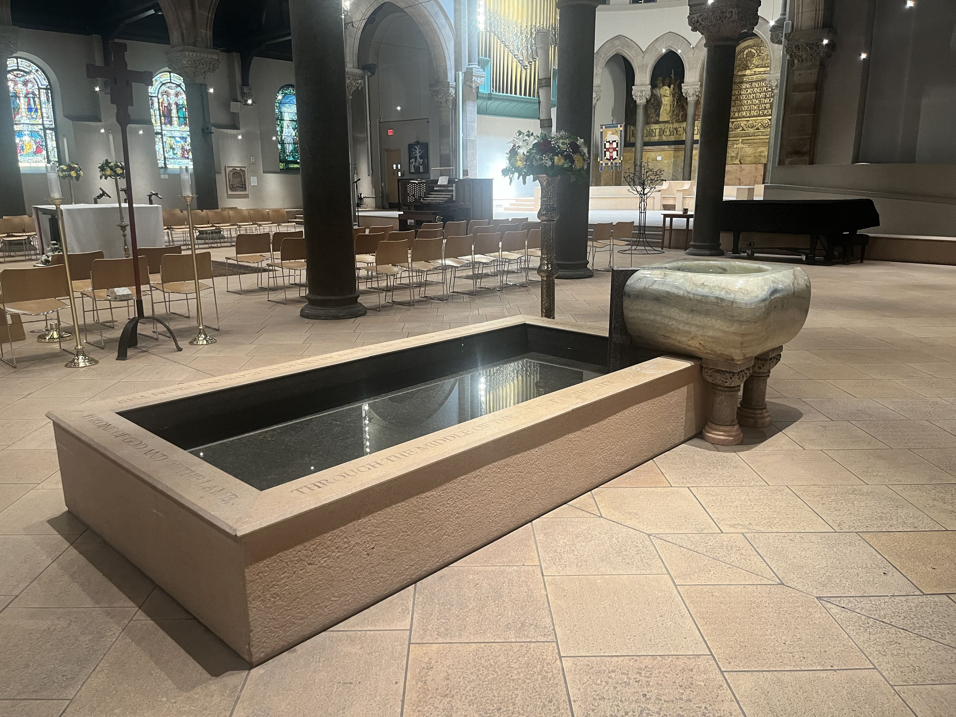 The Philadelphia Episcopal Cathedral’s baptismal font donated by Anthony and Ellen can be seen in the top right of the pool. The stained-glass window dedicated to Anthony can be seen on the farthest right in the background, partially obscured by the column. 