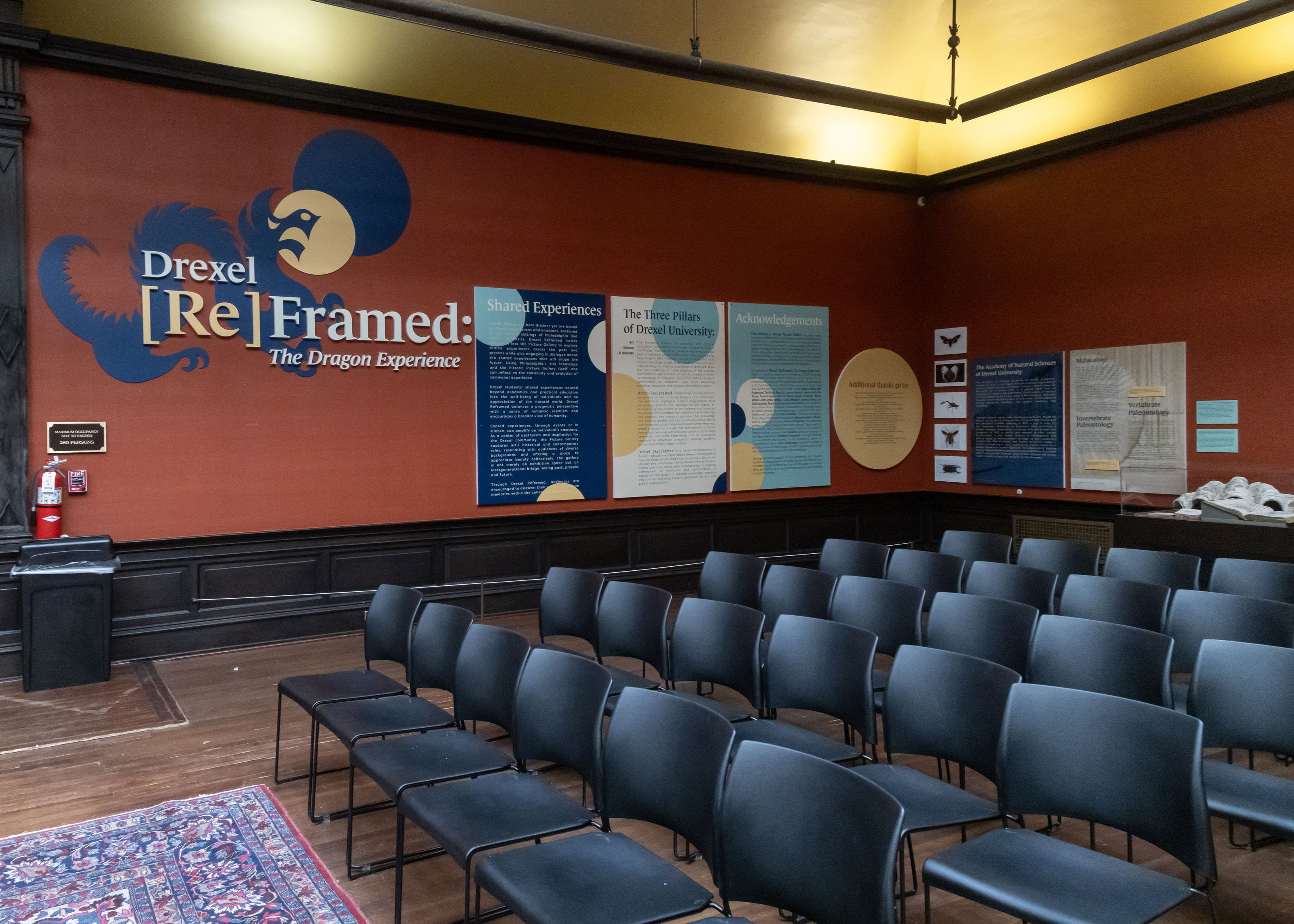 Student-written labels on a wall describing the intent behind the exhibition.