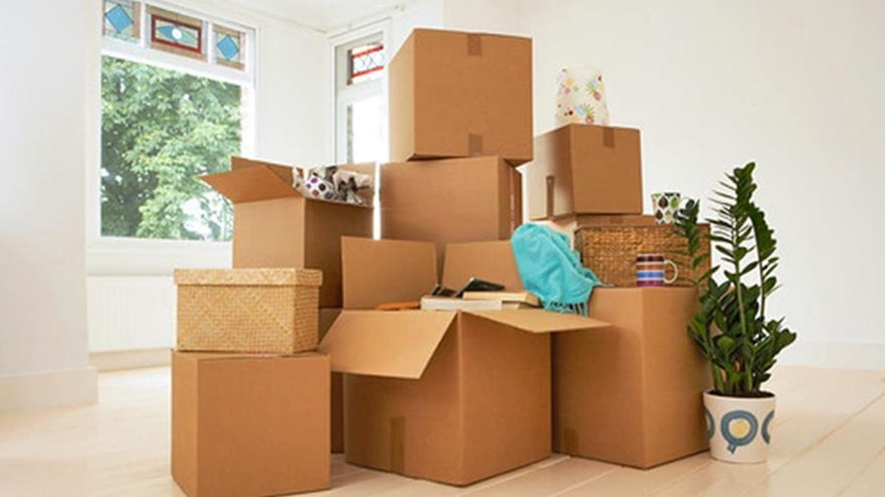 A stack of cardboard boxes in an empty room