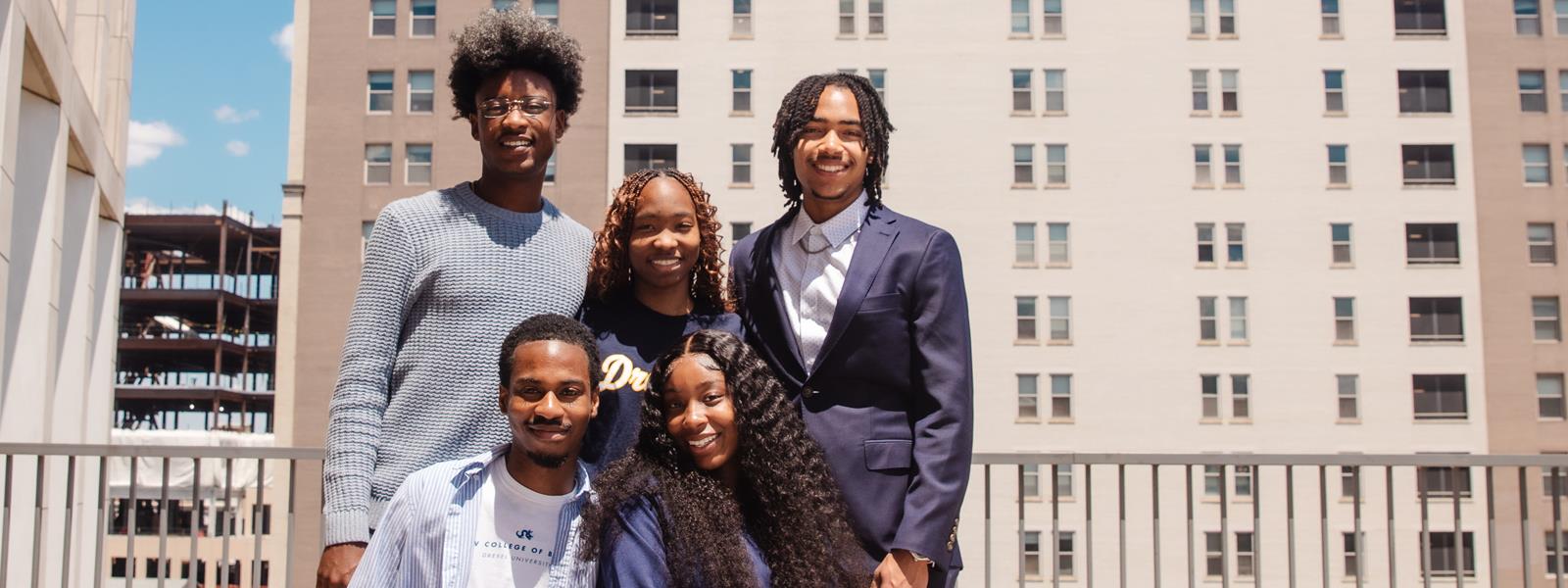 Five students in front of University Crossings