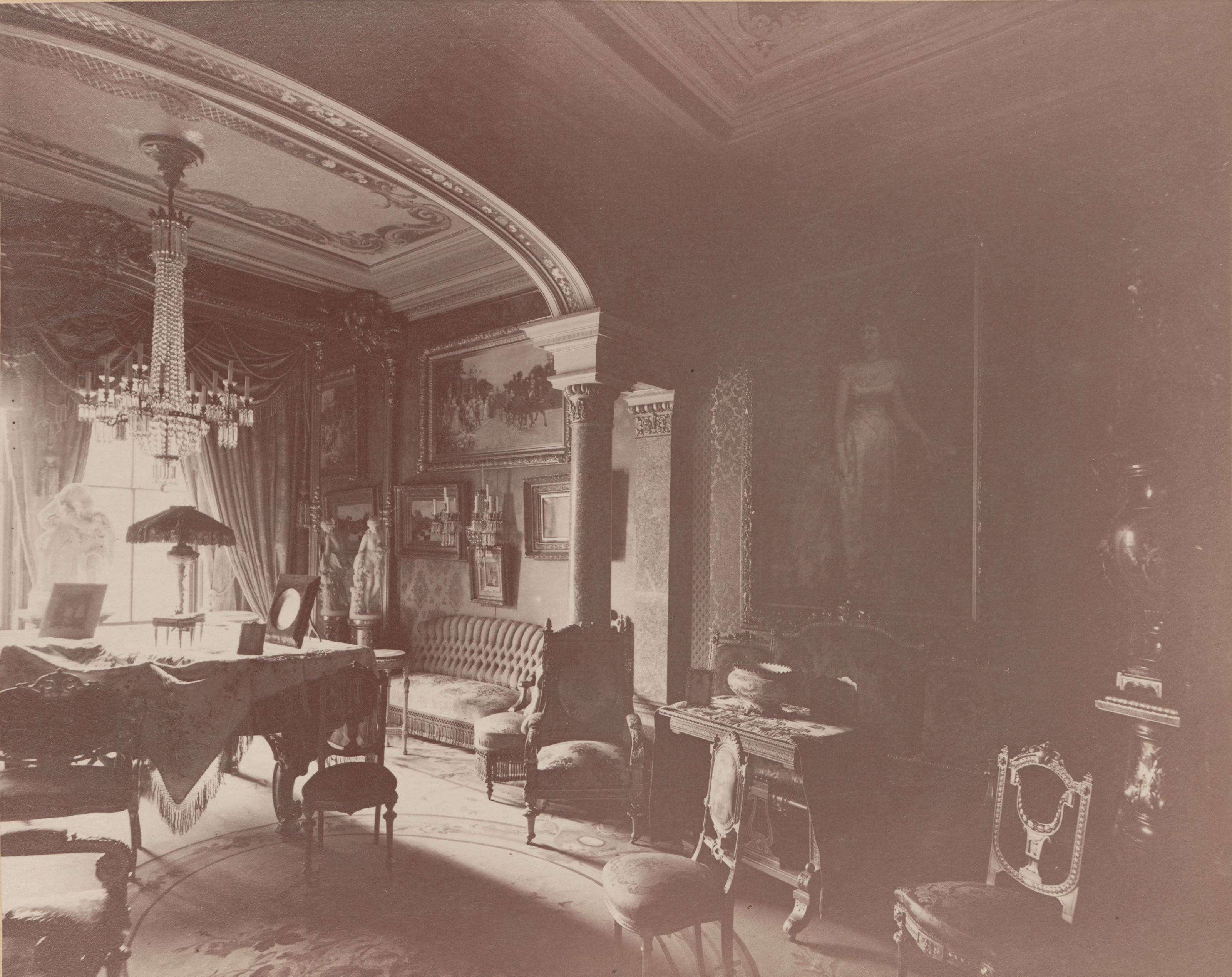 The reception room at Anthony’s house, which shows “After the Wedding” hanging above the other paintings above the couch in the far corner of the room. This is one of the undated photographs from the Drexel family photo book that Mayes researched and included in the exhibition. Photo courtesy Drexel University Archives. 