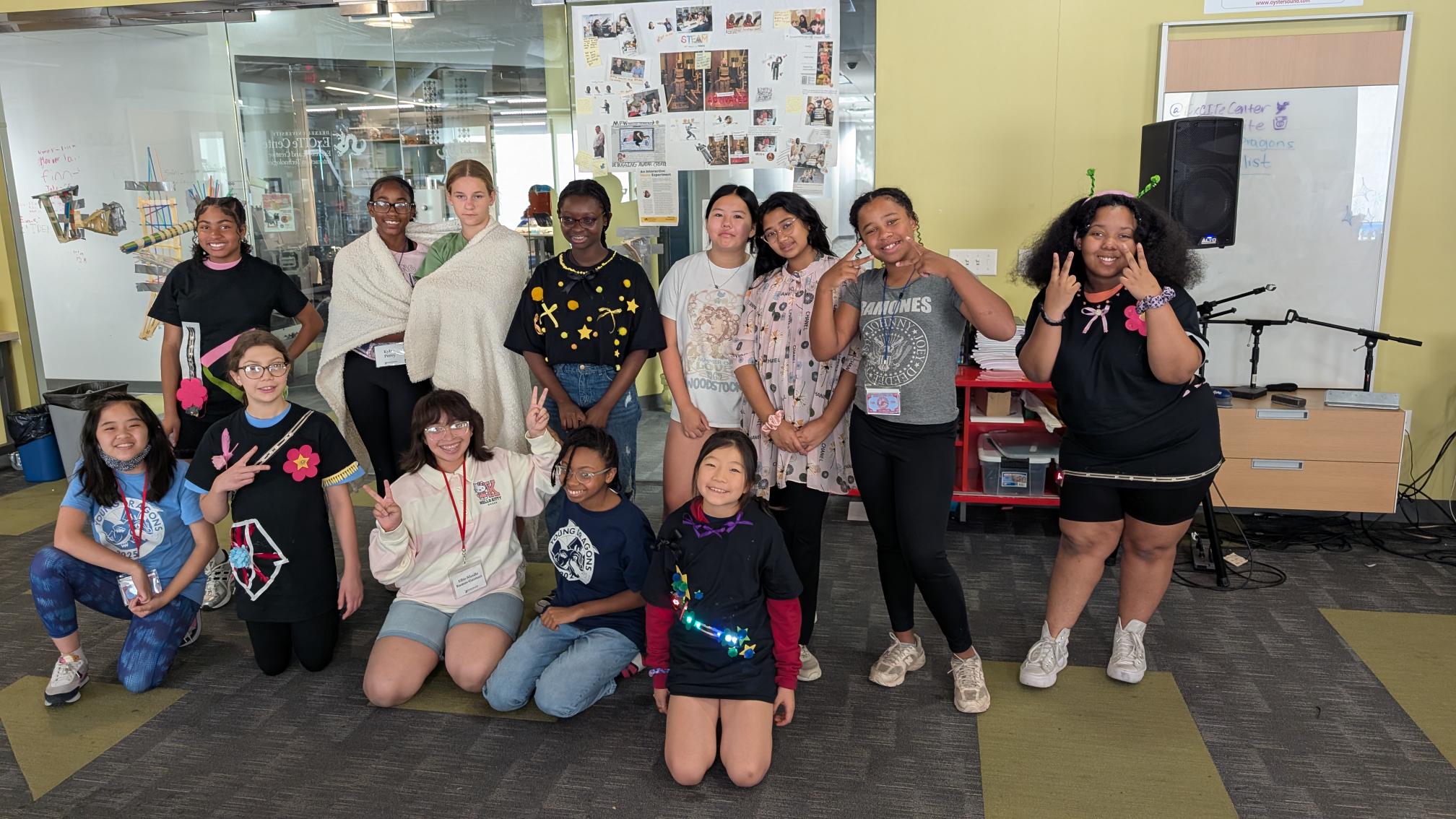 A row of children standing and sitting in a row.
