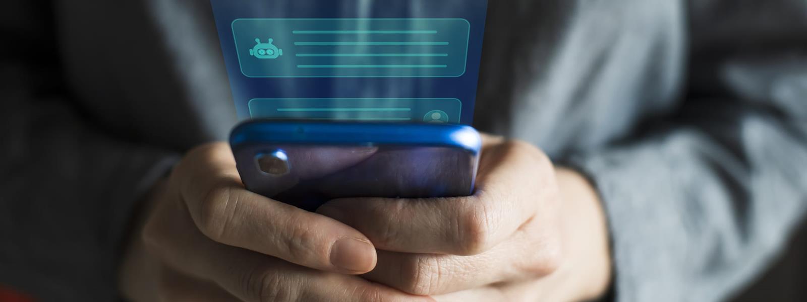 Person typing on phone to AI chatbot.