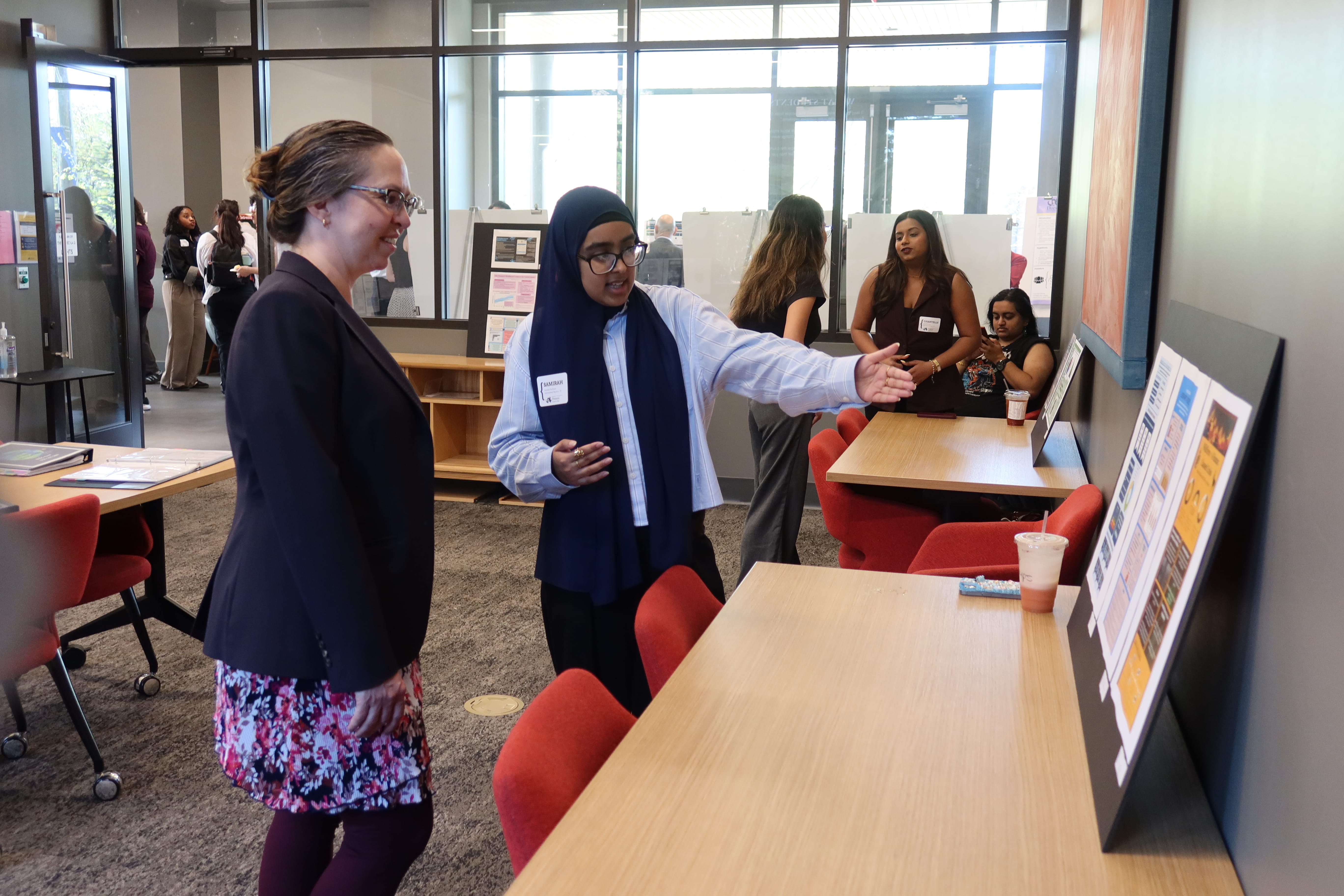 Student showing research at Pennoni showcase