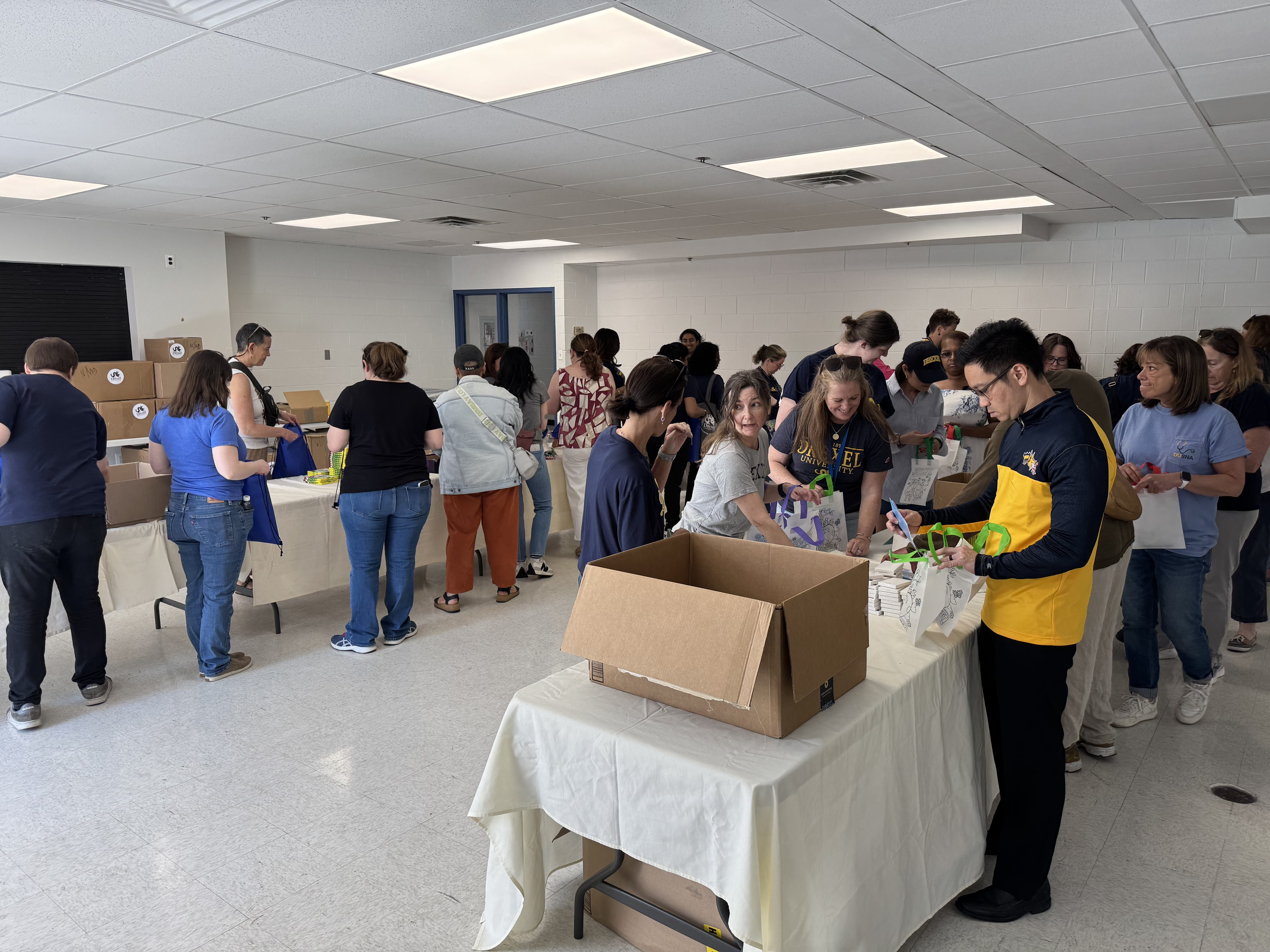 Attendees packing kits at Dornsife Center