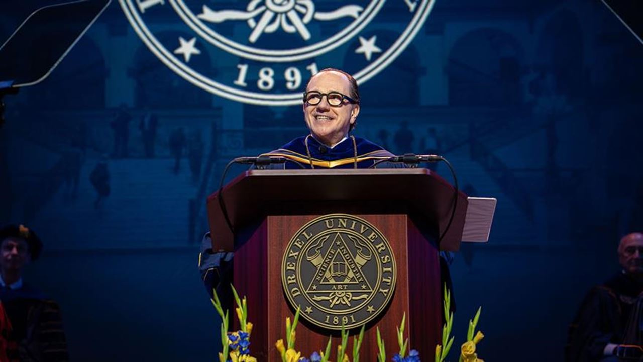 President Antonio Merlo at a podium in his robes