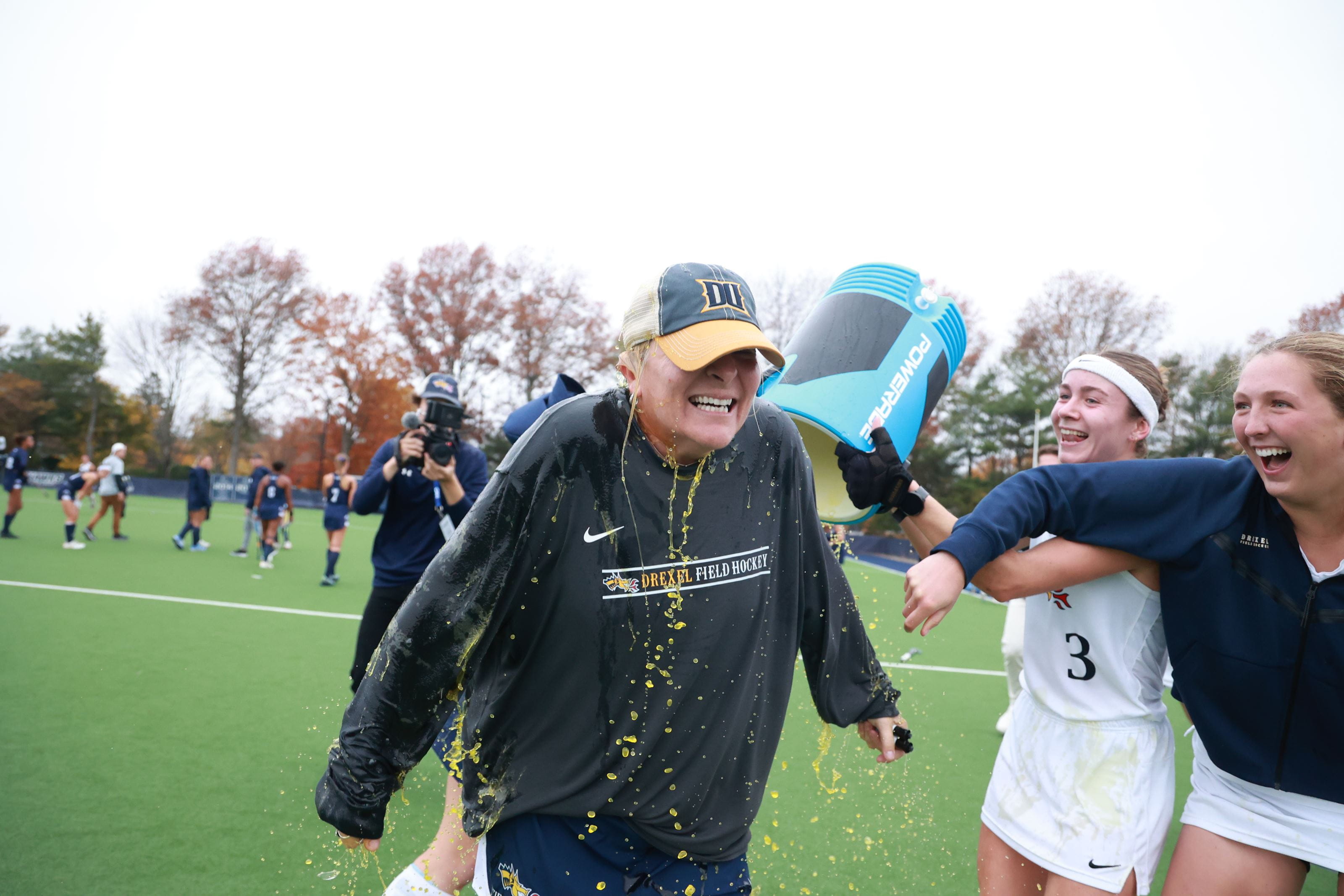 Coach Denise Zelenak gets doused with Gatorade after the CAA championship. 