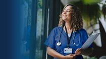 nurse smiling looking out a window