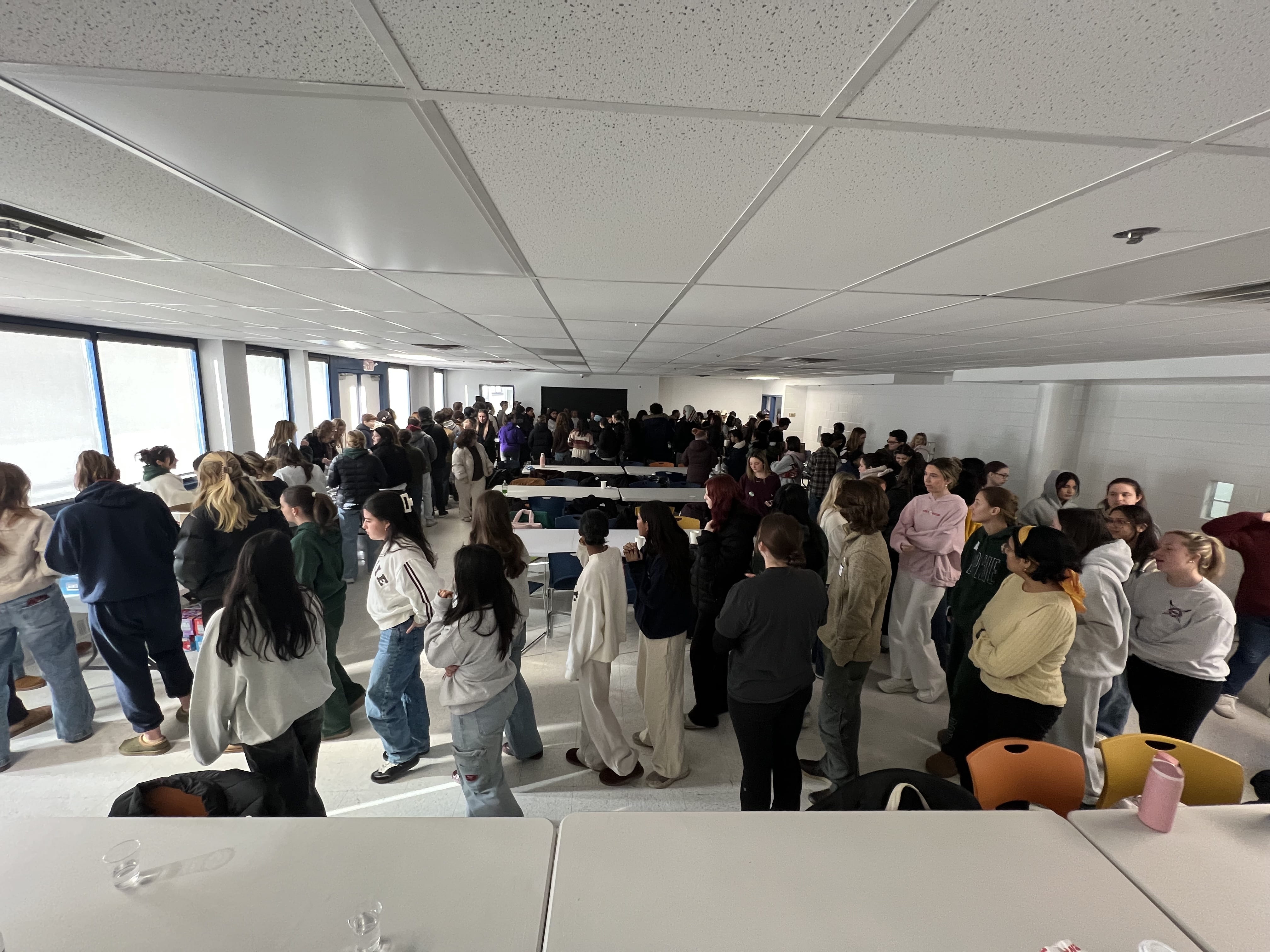 Students get ready to pack kits at the Dornsife Center