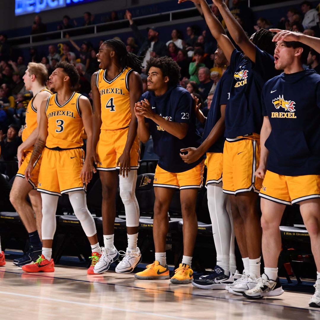 The men's basketball team cheers during the 2025 Homecoming game