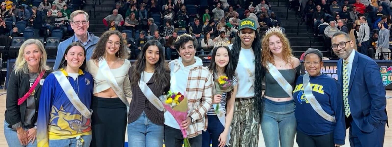 A row of students from Drexel's Homecoming Court posing for a photograph at the DAC.