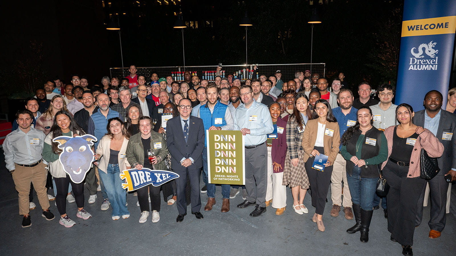 President Antonio Merlo, center, surrounded by a group of people at Drexel's Night of Networking.