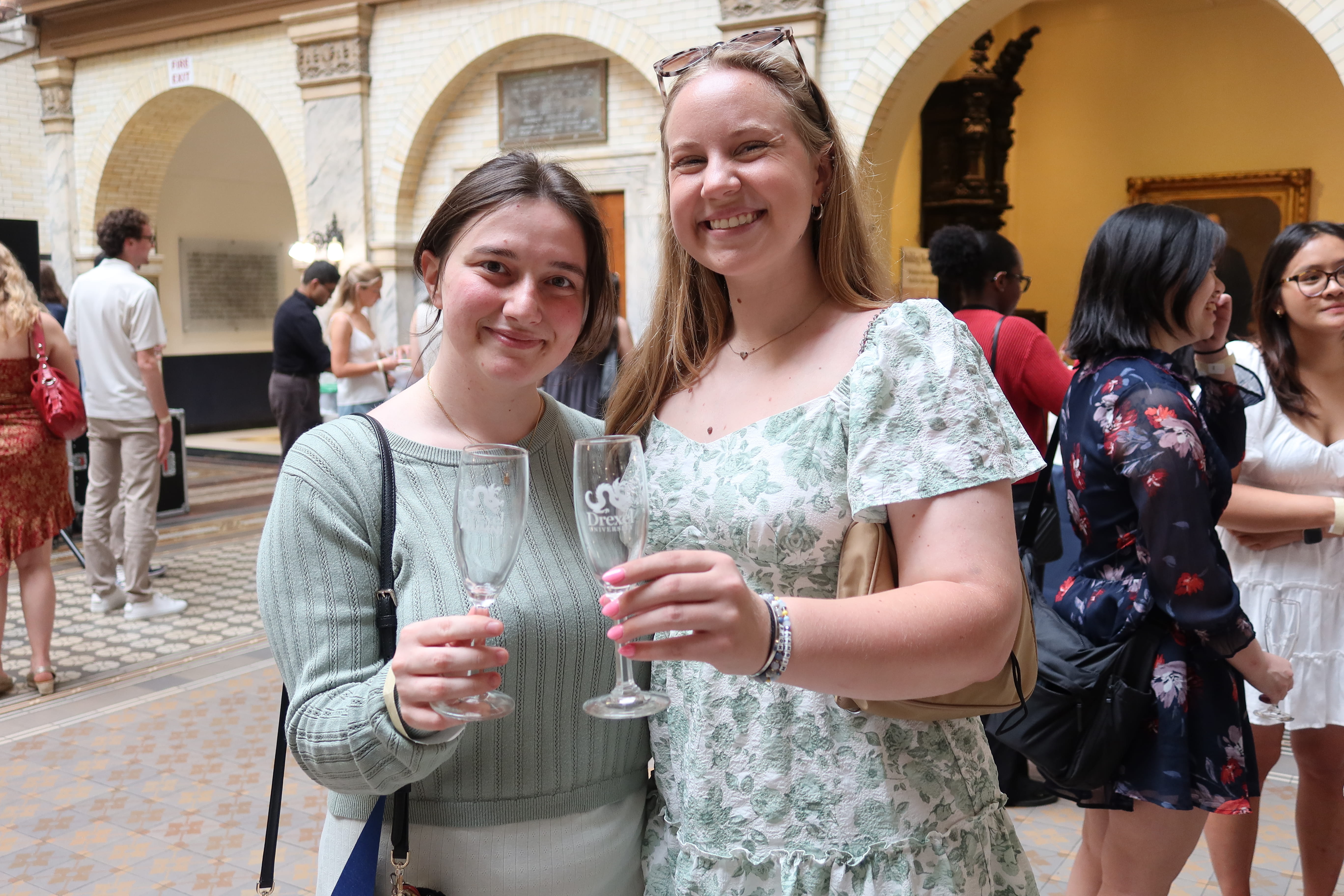 Two students with champagne glasses