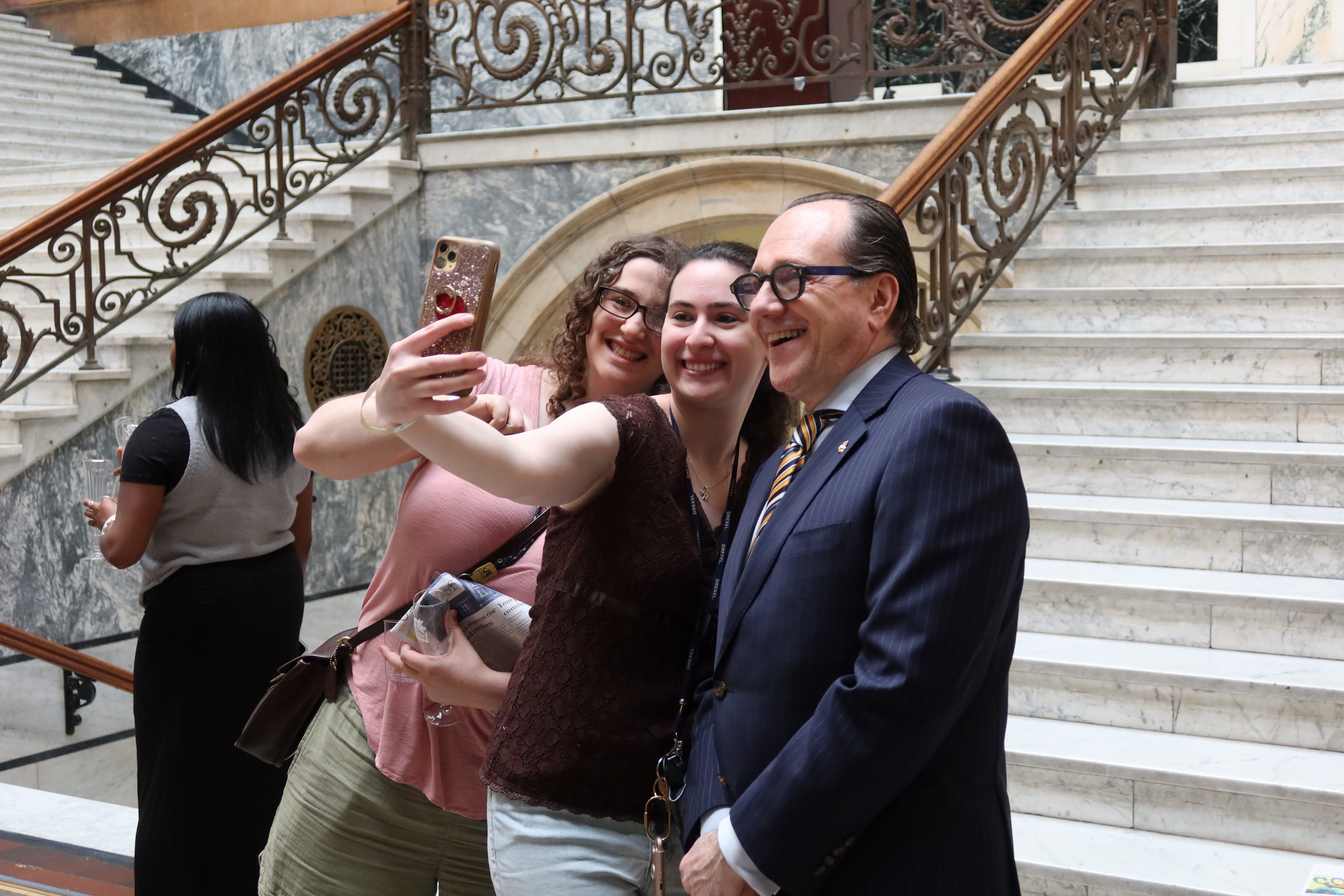 Merlo snaps a selfie with two students