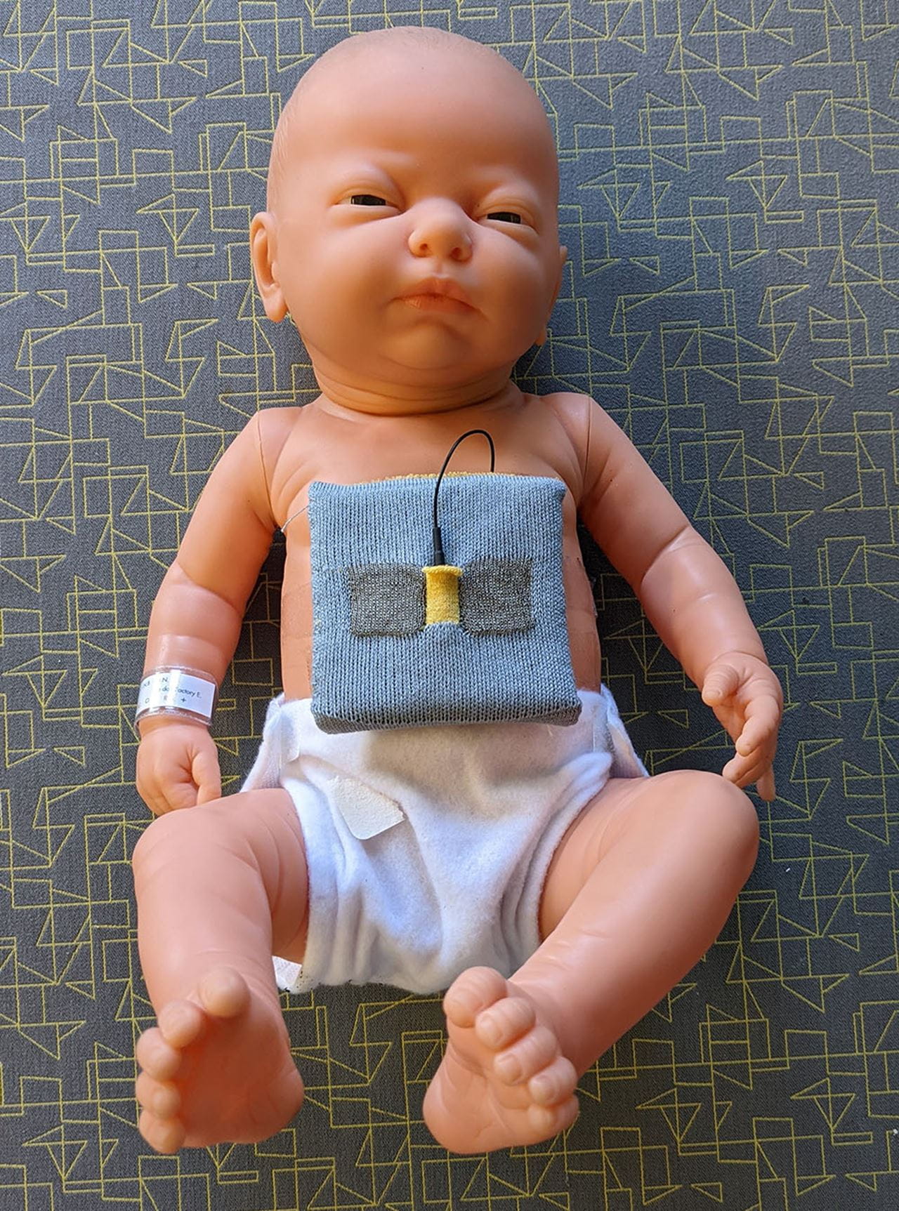 A baby doll wearing a Belly Band prototype.
