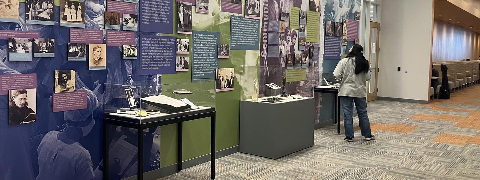 Daniela Lopez, graduating psychology major, viewing the Legacy Center’s new Health Sciences History Gallery on the second floor of the Health Sciences Building. Photo courtesy Legacy Center Archives & Special Collections.