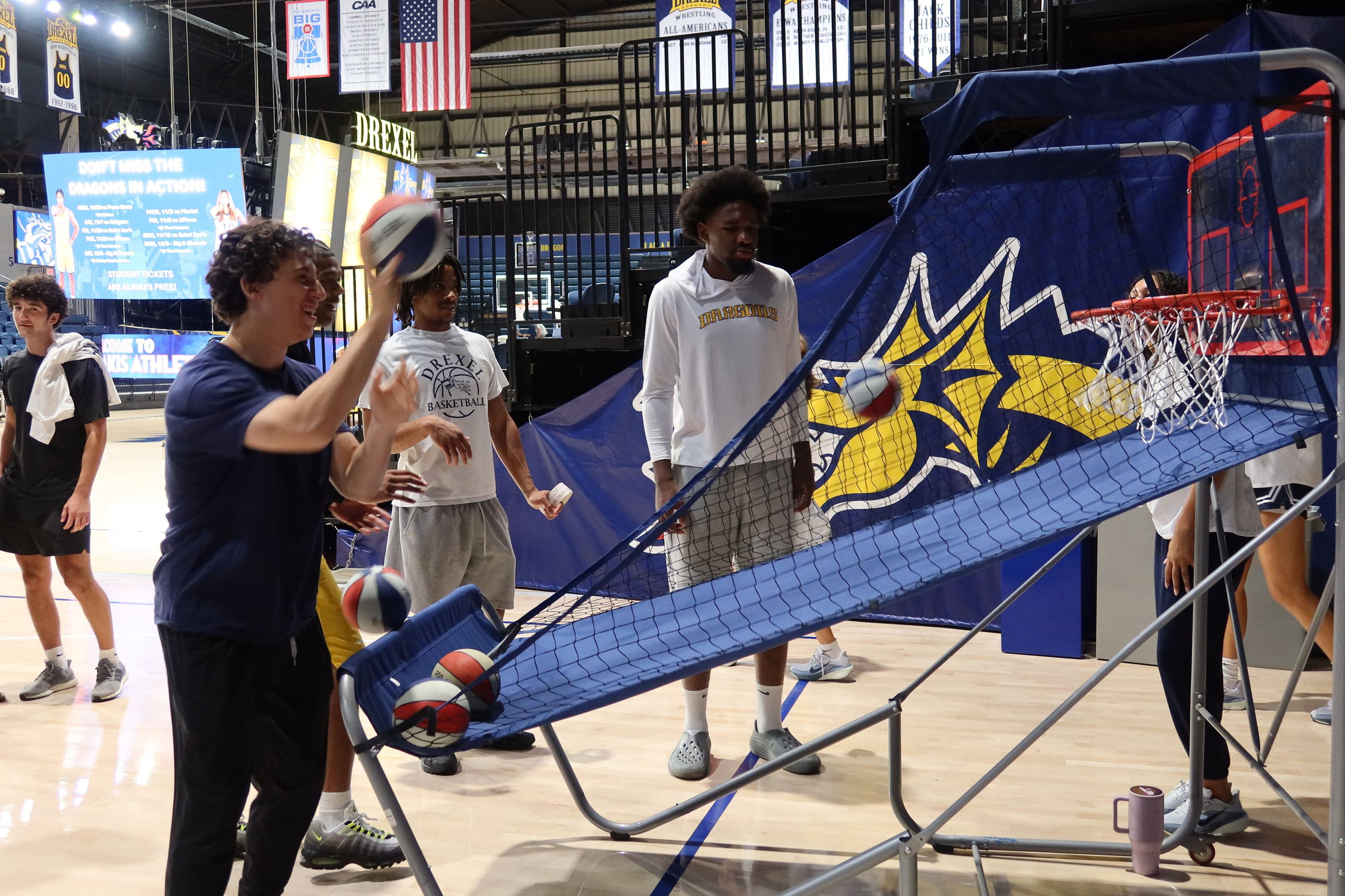 Students playing pop a shot basketball
