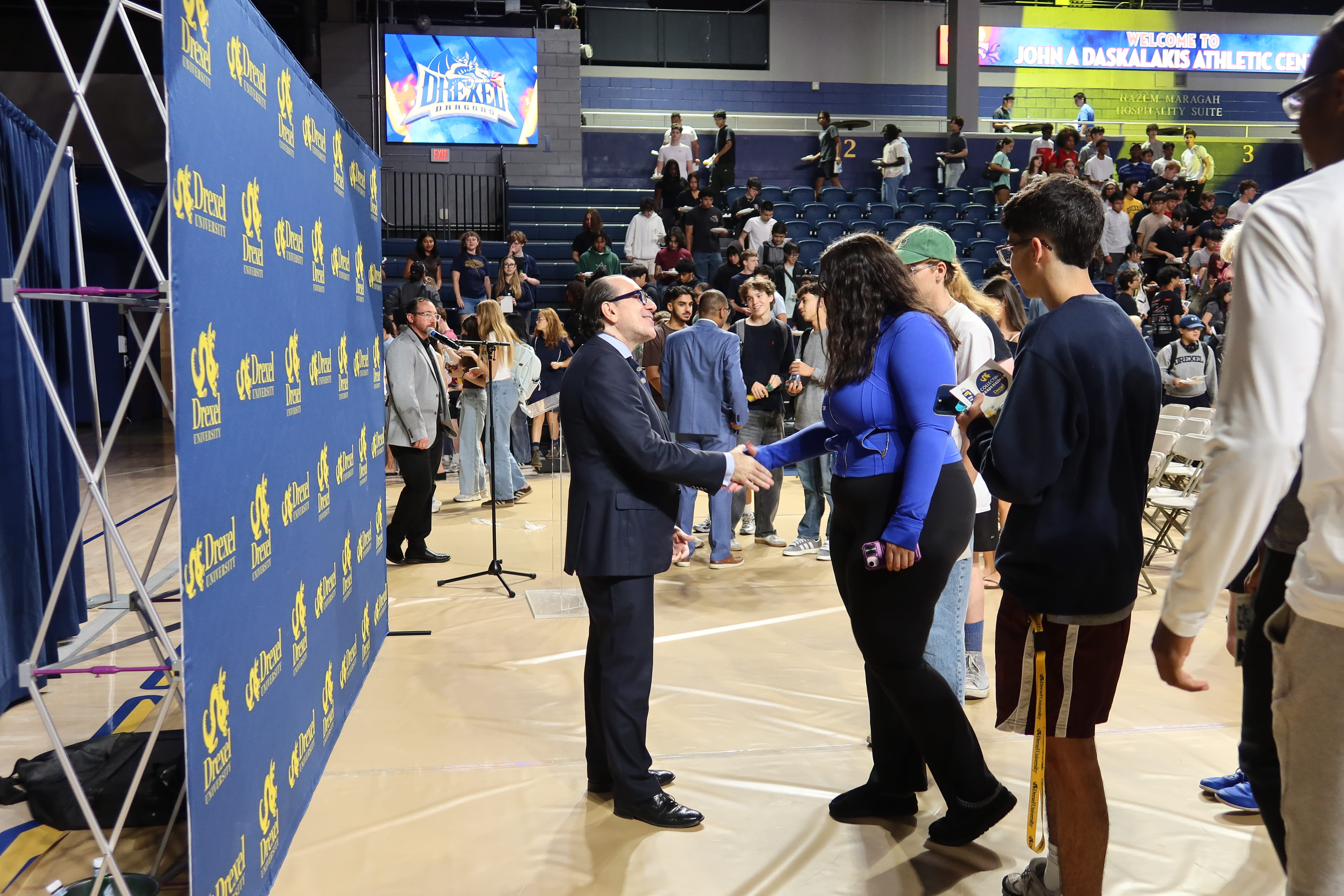 Merlo shakes hands with students after breakfast