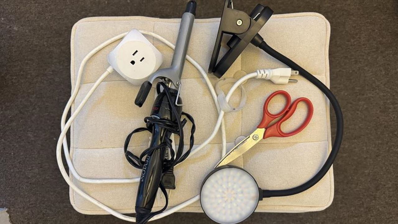 collection of items including hair curler, lamp, scissors, extension cord 