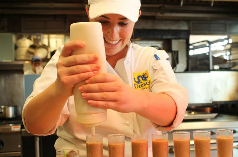 Dana Bloom, an undergraduate culinary arts major in Drexel's Center for Hospitality and Sport Management, tests recipes in the Drexel Food Lab.