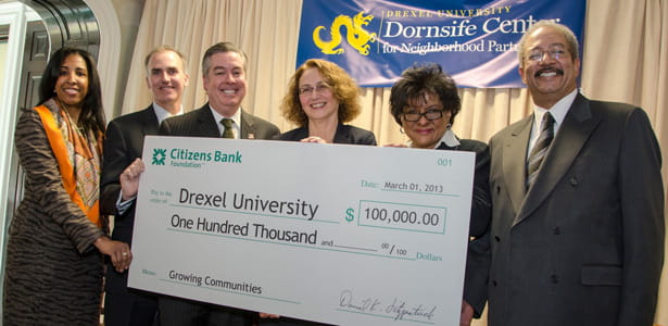 Drexel and Citizens Bank representatives with government officials and a $100,000 check