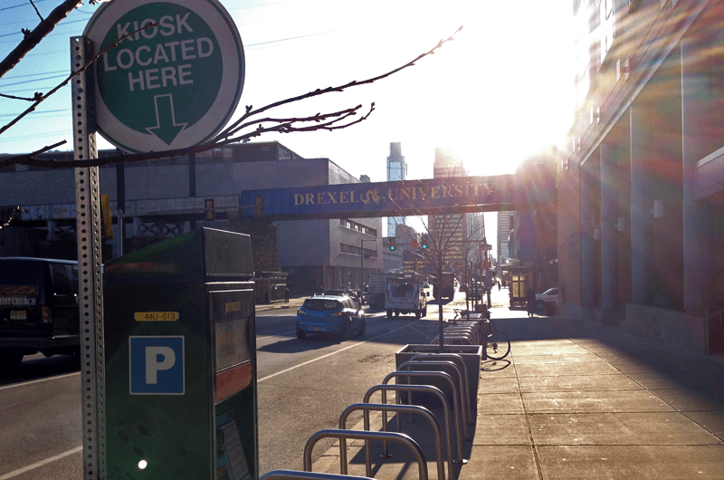 A parking kiosk in University City, Philadelphia, is adjacent to bicycle racks, a bus stop and a subway station.