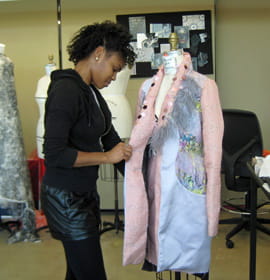 Amber J. Cuff puts the final touches on a jacket from her collection.