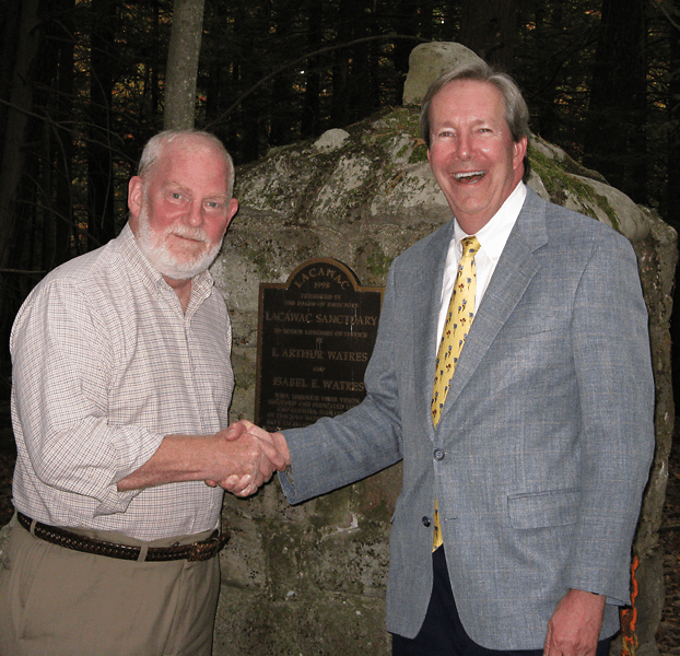Stephen C. Lawrence (left), chairman of the Lacawac Sanctuary Foundation, and George W. Gephart, Jr., president and CEO of the Academy of Natural Sciences of Drexel University, shake hands over an agreement to form an environmental research and educational consortium at Lacawac in the Pocono Mountains. The consortium also includes Drexel University.