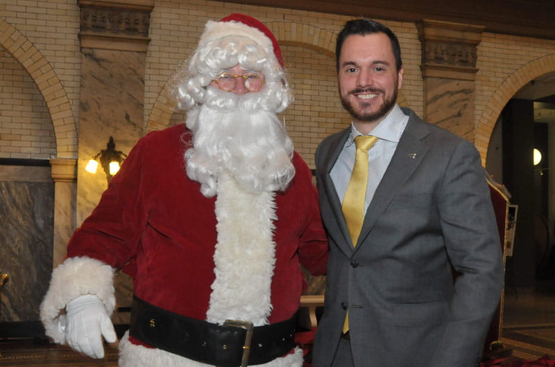 Dimitrios Boufidis, who helped spearhead the toy drive, poses with Santa.