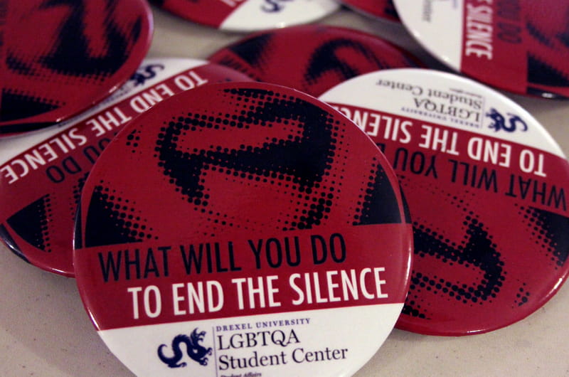 A collection of pins given out to wear during the National Day of Silence at Drexel.