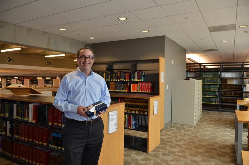 Daniel M. Filler, JD, senior associate dean for Academic and Faculty Affairs in the Kline School of Law, holding the iPad he won as a part of a drawing for taking part in the 2014-15 Why I Give campaign.