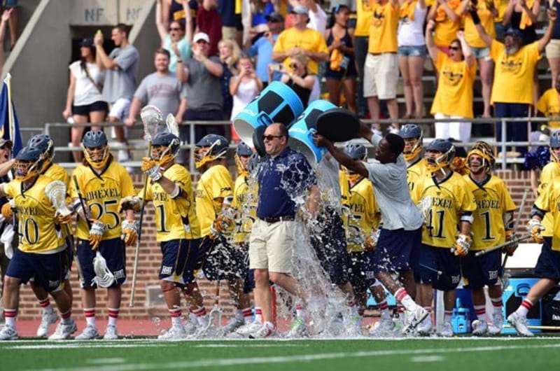 Drexel men's lacrosse celebrates its first-ever NCAA tournament victory by dumping Gatorade on coach Brian Voelker