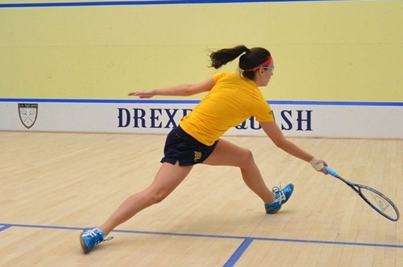 Women's squash player in action.