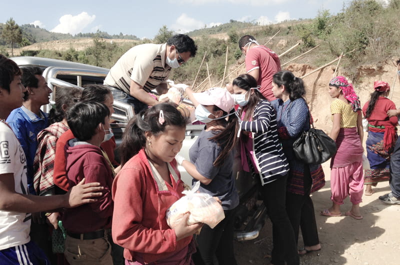 Relief workers handing out food in Nepal in the days following devastating earthquakes in April.