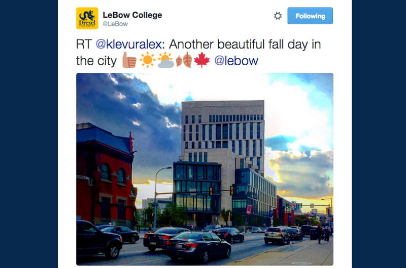 A Tweet reading "Another beautiful fall day in the city" and Gerri C. LeBow Hall at twilight.