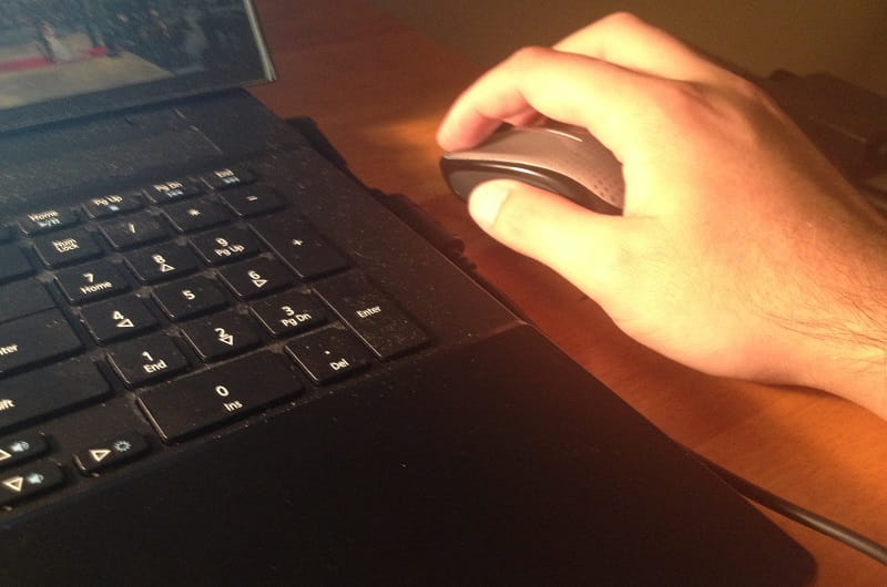 A hand with a mouse and a keyboard.