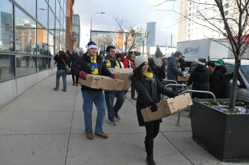 Volunteers carry turkeys to their recipients during the Turkey Project.