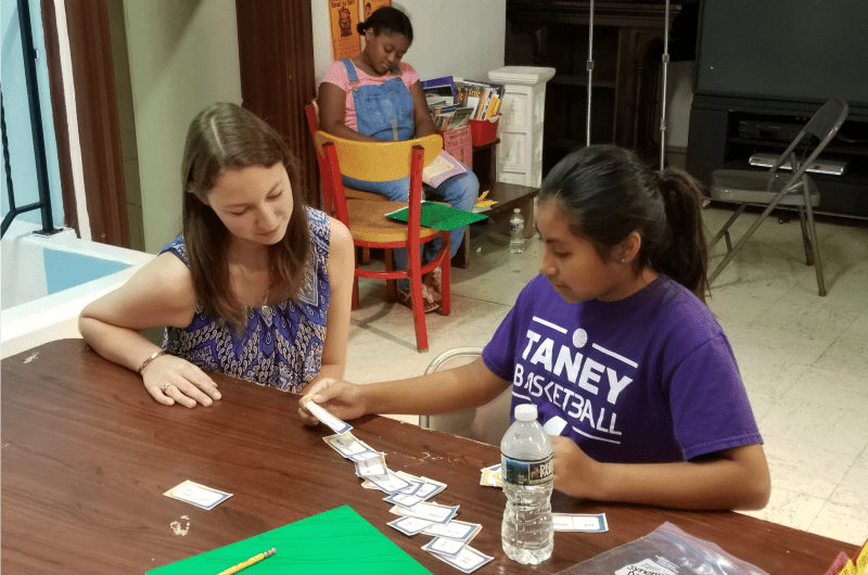 Kim DelPorte works with a student at Drexel's Summer Literacy Camp.