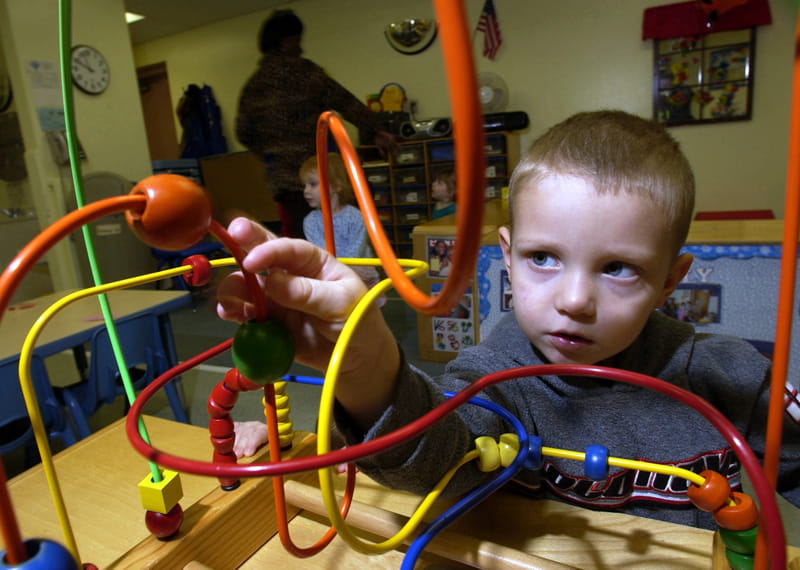 A child playing with a toy at a daycare.