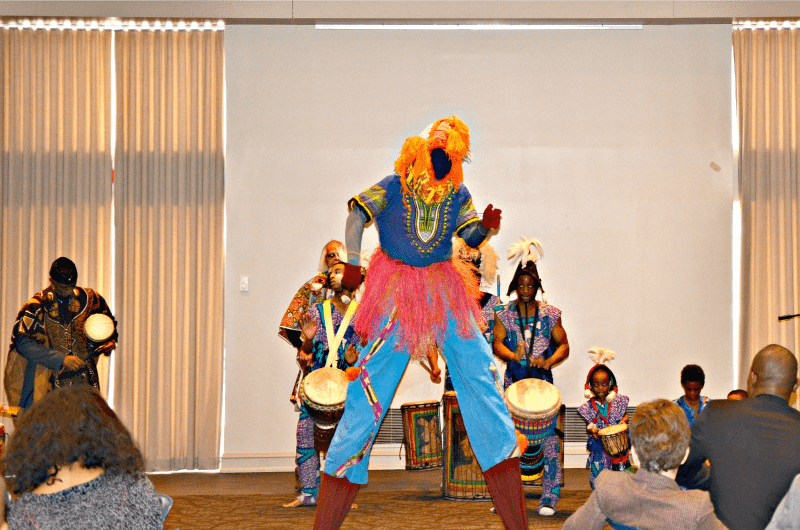 A faceless stilt-walker performs with the Universal African Drum and Dance Ensemble.