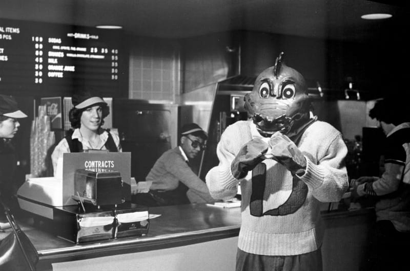 A Drexel dragon holding a burger at the Dragon's Den in 1979. Photo courtesy University Archives.