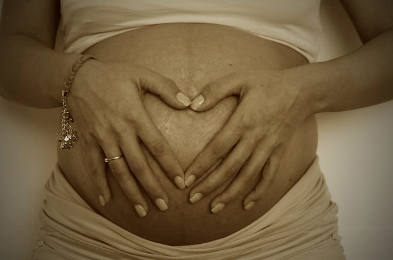 A pregnant woman holding her stomach
